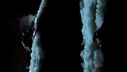 SLO MO climber chopping ice with his axe at night Stock Footage