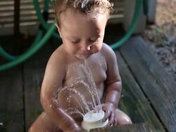 MS Shot of baby boy playing in outdoor shower / St Simon's Island, Georgia, United States Stock Footage
