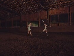 wide shot of two dancers dancing in wooden barn Stock Footage