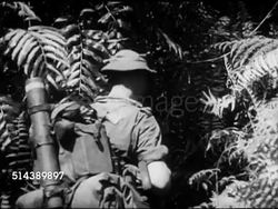 1953: PATROLLING MALAYA JUNGLE: VS Native scouts leading British soldiers, hacking into vegetation, wading through stagnant water, SOFT FOCUS Thick mud, soldier climbing out of bracish water creek, second soldier jumping toward far bank, hand helping. Instructional Video
