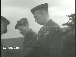 1948: GREECE: COLD 'SHOOTING' WAR: MS British, American & Greek Generals, Officers on hill looking at map. MS American officer looking w/ binoculars. WS Greek soldiers carrying wounded on stretcher on hillside. Mountain warfare Instructional Video