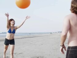 MS SLO MO  Young couple playing with beach ball at beach / Isle of Palms, South Carolina, USA Stock Footage