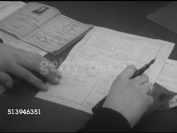 1953: REFUGEES: BERLIN, GERMANY: VS East Berlin refugees conducting interview, male filling out forms, various refugees stamping fingerprints. Berlin Wall, occupied city Instructional Video