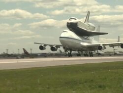 Space shuttle Enterprise, mounted atop a 747 shuttle carrier aircraft, lands at Space Shuttle Enterprise Lands At John F. Kennedy International Airport Stock Footage