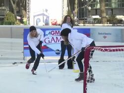 Amy Elizabeth Freeze "The Big Freeze" (GMAâ€™s meteorologist), Lara Spencer & Sasha Cohen (figure skater & 2006 Olympic silver medalist) having a hockey shootout at the Ice Rink in Bryant Park Stock Footage