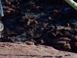 MS SLO MO Man leaping off cliff in desert / Moab, Utah, United States   Stock Footage