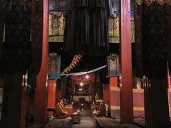 WS Shot inside of Buddhist temple with lamas sitting and praying / Lhasa, Tibet, China Stock Footage