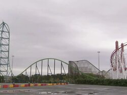 Wide Shot static - Storm clouds loom above a roller coaster / Six Flags Great Adventure Jackson, NJ Stock Footage