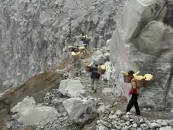WS Miners climbing the Ijen volcano crater carrying solid sulfur / Ijen, Java, Indonesia Stock Footage