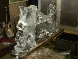 An artist uses a chain saw to create a dragon made of ice. Stock Footage