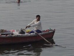 WS PAN Man rowing boat in Ganges river / Varanasi, India Stock Footage