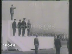 1942: JAPAN: MILITARY RALLY: * WS Flag of Japan & Manchukuo flying on pole. VS Imperial Japanese Army (IJA) soldiers marching during rally for officers, including Emperor Hirohito (BACK shot only). VS Soldiers marching in formation. WWII Instructional Video