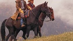 SLO MO DS Two male ranchers riding horses and talking Stock Footage