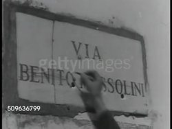 1941: NORTH AFRICA: Australian soldiers walking up to building w/ ' Via Benito Mussolini' sign, crossing out Benito Mussolini adding ' Australia '. ANZACS (Australian Army &amp; New Zealand Army Corps) WWII Instructional Video