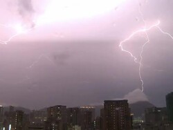 Massive fork of lightning strikes a mountain top at night, Hong Kong Stock Footage