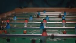 Guys playing tabletop soccer in apartment Stock Footage