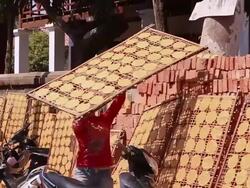 MS TS SLO MO Shot of Woman carrying panel loading with cassava crackers / Luang Prabang, Laos Stock Footage