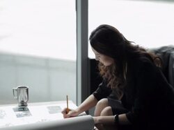 MS Young business woman writing, sitting at coffee table by window/ Beijing, China Stock Footage