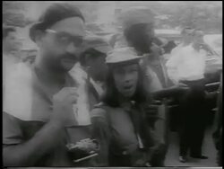 B/W 1959 guerrilla soldier holding rosary with woman smiling beside him / Cuba / newsreel Stock Footage