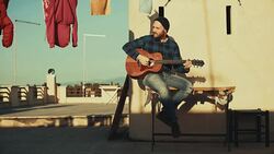 Hipster man playing acoustic guitar on the terrace Stock Footage