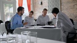 Restaurant owner leads daily staff meeting Stock Footage