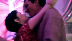 Young man pulls young woman into embrace under the bright lights of downtown Las Vegas Stock Footage