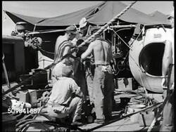 1945: PHILIPPINE SALVAGE DIVER: WS Boat resting in harbor. WS American men suiting up under-water diver, tightening suit. CU Tying boots. CU Putting diving helmet onto diver. MS Naval officers talking. Instructional Video