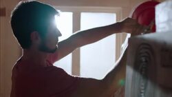 Shop worker ties price tags to specialty longboards in Wood Studio Stock Footage