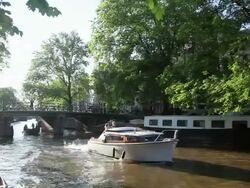 WS View of boats moving underneath bridge / Amsterdam, The Netherlands, Holland Stock Footage