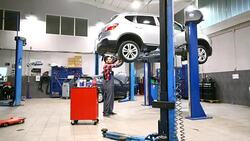 Car mechanic working under a vehicle. Stock Footage