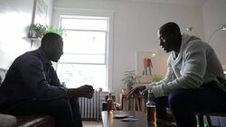 Men drinking beer and playing cards at living room coffee table Stock Footage