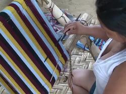 Woman weaving fabric to a frame, village of Mapajo inhabited by the tribe of Mosetenes, Bolivia, Amazon Stock Footage
