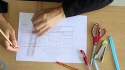 Female drawing house in office Stock Footage
