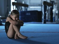 MS PAN Lone girl (6-7) sitting on floor, four girls (6-7, 8-9) chatting and laughing in gym, Orem, Utah, USA Stock Footage