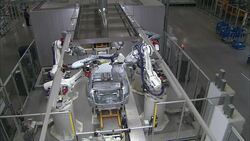 Robots weld automotive parts on an assembly line. Stock Footage