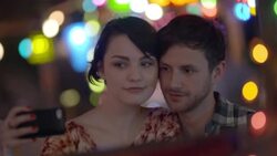 Young couple take selfies together in booth of Austin caf_ Stock Footage