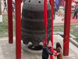 MS TD Couple knocking bell to pray for good luck at temple fair to celebrate Chinese spring festival / xi'an, shaanxi, china Stock Footage