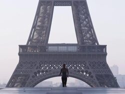 woman running in front of the Eiffel tower Stock Footage