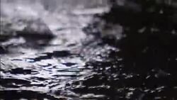 Rainwater splashes as it falls into a stream. Stock Footage