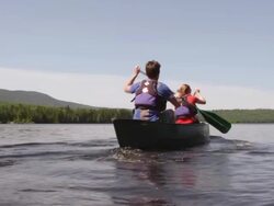 MS TU Shot of Couple canoeing on Long Pond with Wilderness / Maine, United States Stock Footage