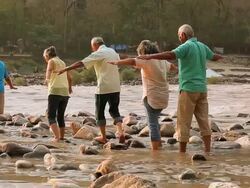 Five senior people walking at riverbank, Ganges River, Rishikesh, Uttarakhand, India Stock Footage