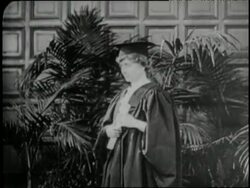 Helen Keller holds her diploma wearing a cap and gown upon her graduation in 1904. News Clip