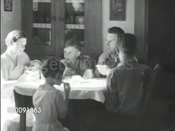 1934: EARLY DUST BOWL: Farm family of six at table, MS Child eating slice of bread w/ thick spread, WS President Franklin D. Roosevelt (FDR) standing w/ son James on back of railroad car, Eleanor walking up BG, banner 'Great Special Northern' FG. Instructional Video