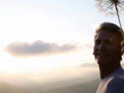 Woman blows across seed cluster, man takes smart phone pic Stock Footage