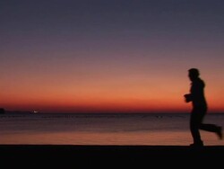 HD: Jogging On The Beach Stock Footage