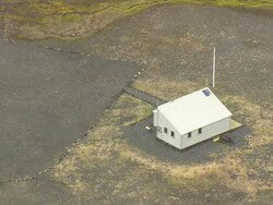 WS AERIAL ZI ZO View of isolated refuge hut near lava plain / Iceland Stock Footage