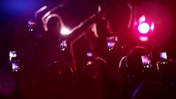 Crowd waving arms holding cell phones at concert Stock Footage