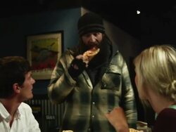 MS Homeless man taking piece of pizza and beverage from restaurant table, surprised couple looking at him, Salt Lake City, Utah, USA Stock Footage