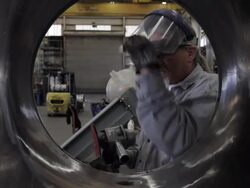 Caucasian worker using sparking grinder on pipe in factory Stock Footage