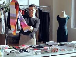 MS Fashion designer sorting through fabric swatches at desk / New York City, New York, USA Stock Footage